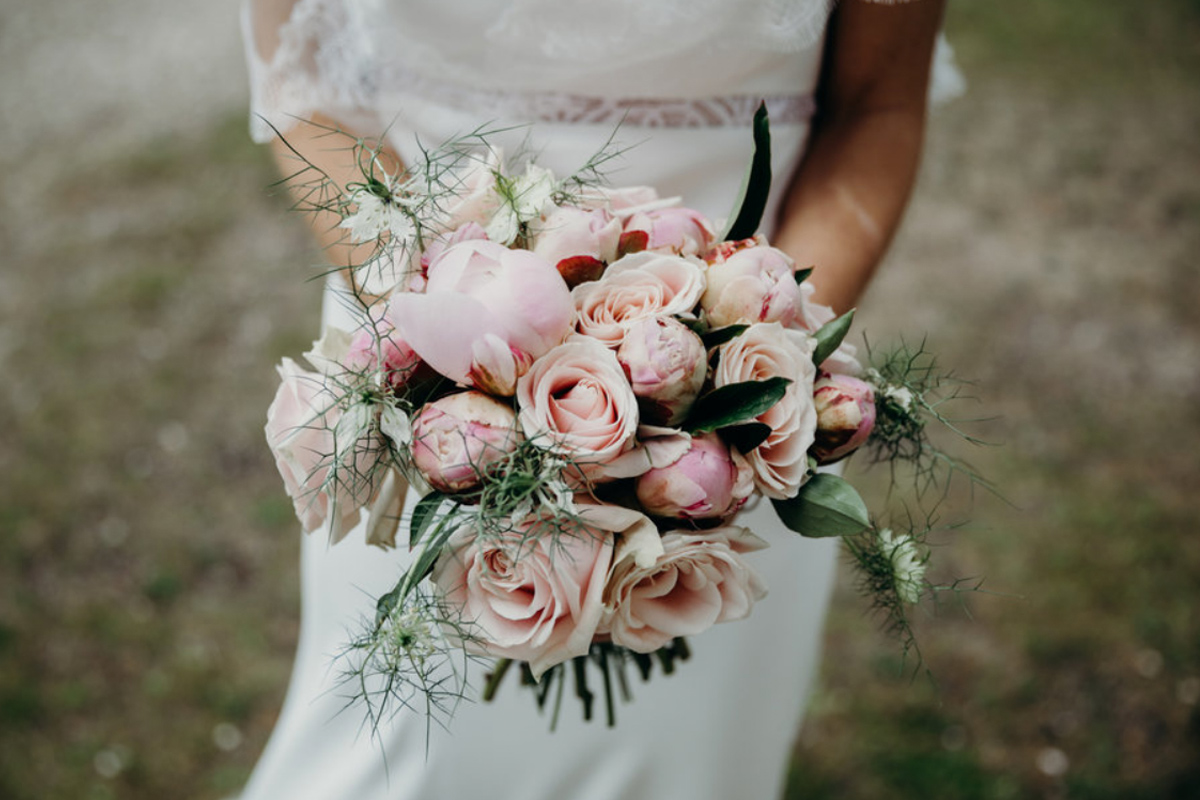 Un bouquet de mariée en roses au thème romantique d'un mariage en fleurs au Domaine de Pétiosse.