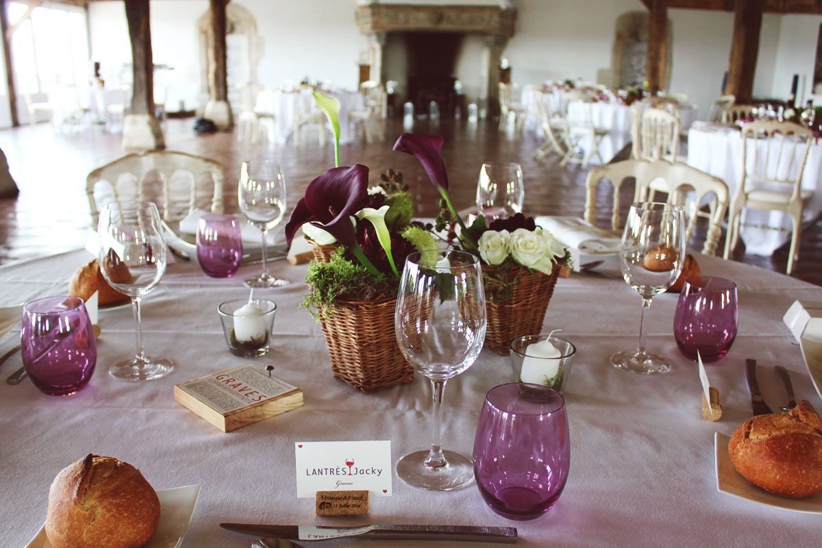 Centre de table en panier en osier de mariage dans un Château aux vignes naturelles.