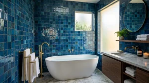 Salle de bain moderne avec carrelage bleu, baignoire blanche, robinetterie dorée